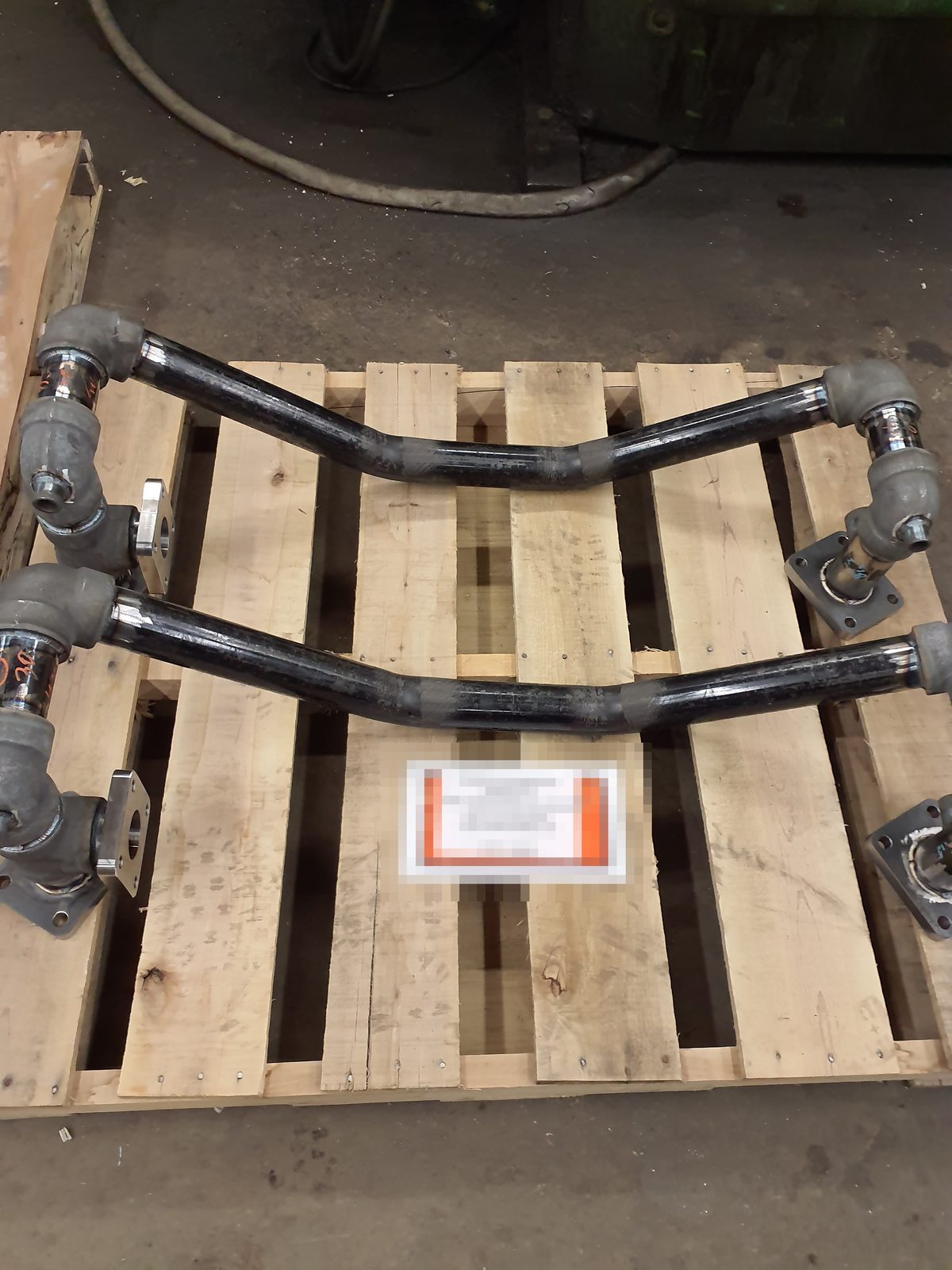 Welded pipe discharge assemblies palletized for shipment