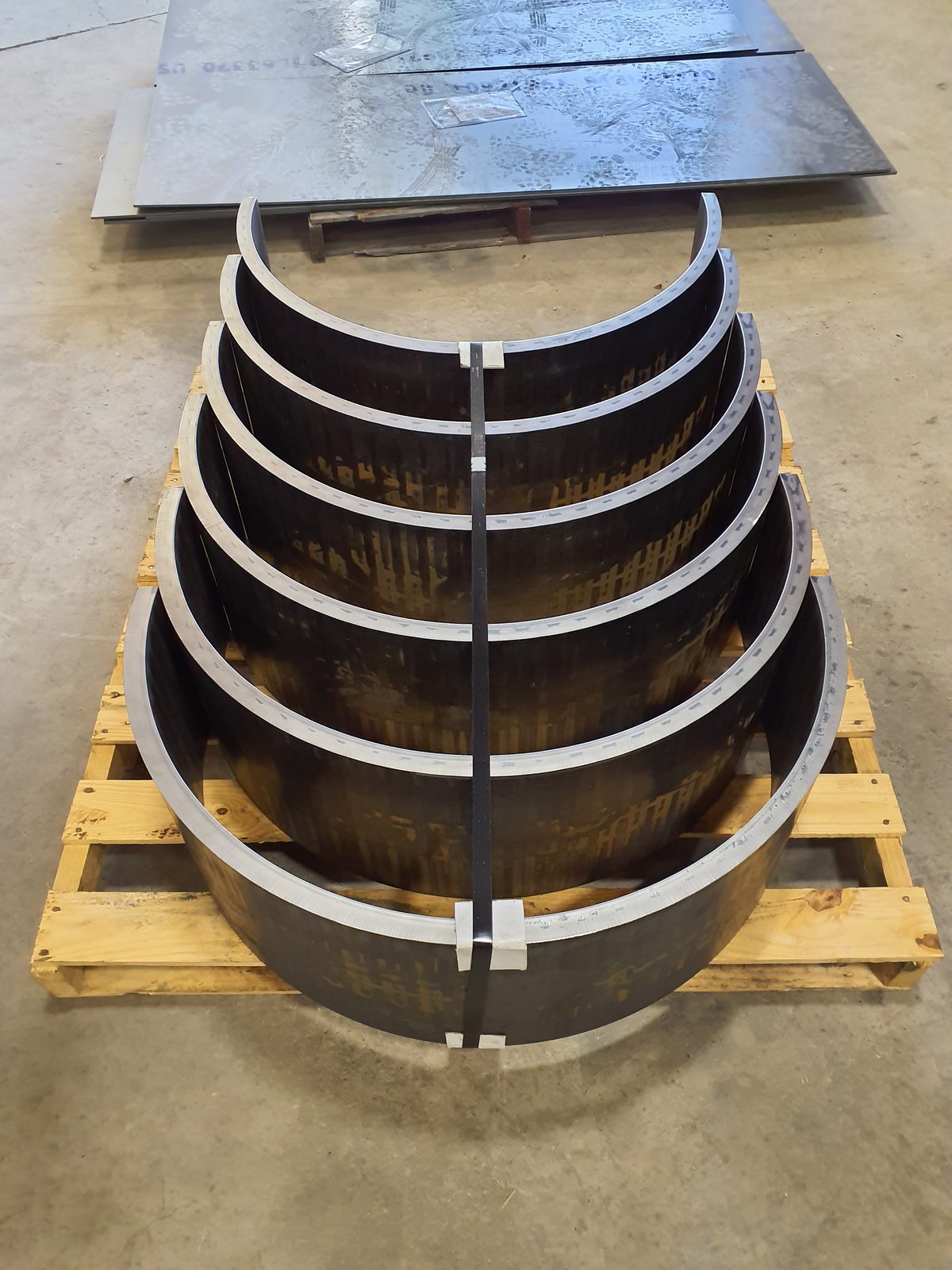 Nested rolled steel half-shells palletized
