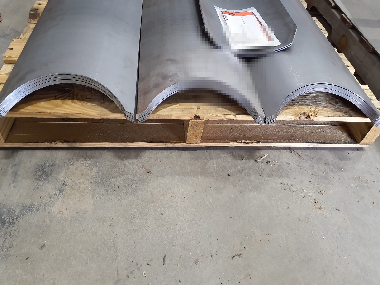 Rolled steel saddle sections stacked for delivery
